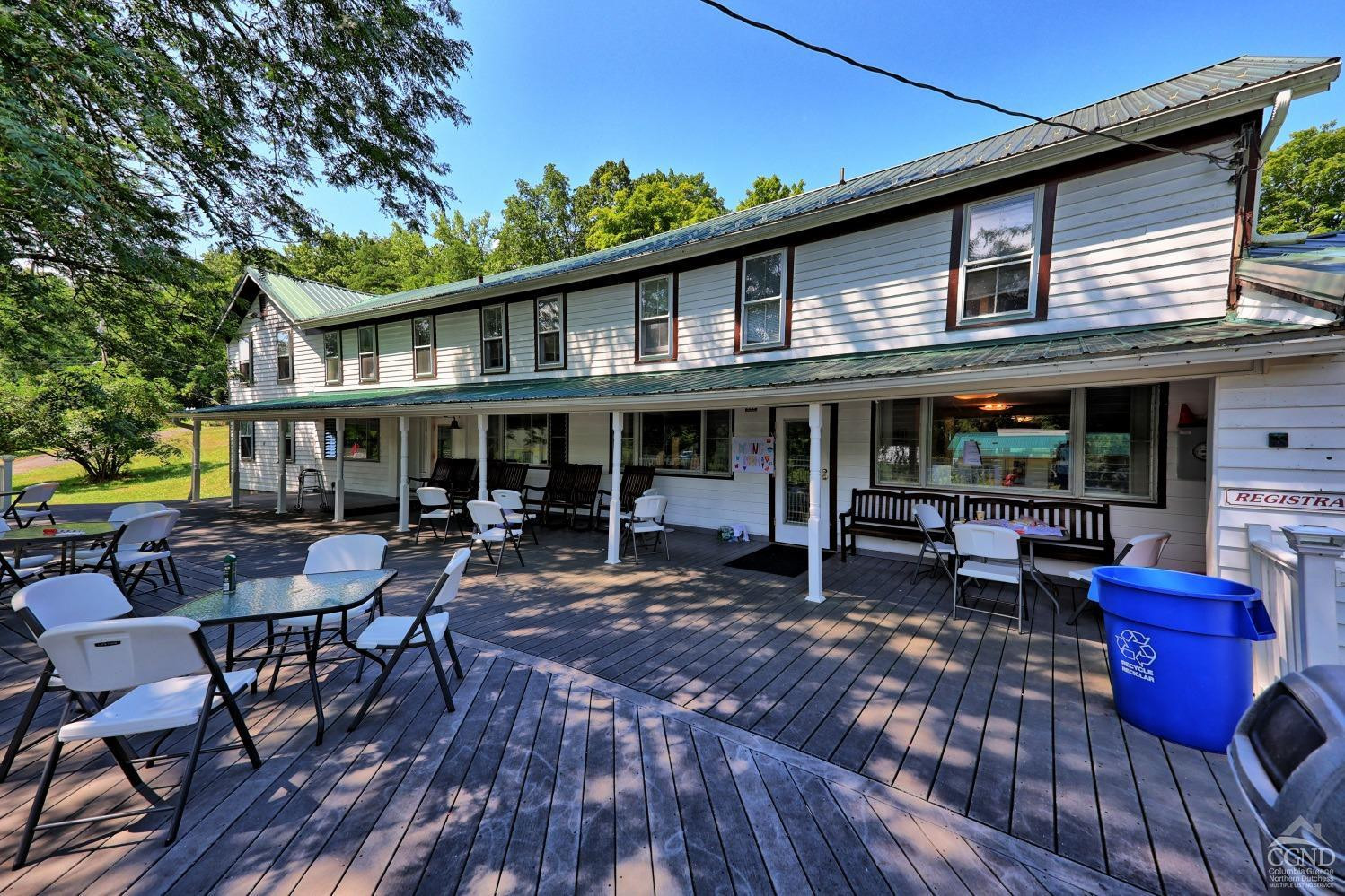 899-907 Red Mill Road Greenville, NY 12083 - Photo 20 of 99 a view of a cafe with table and chairs under an umbrella