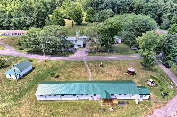 an aerial view of a house with a garden and swimming pool
