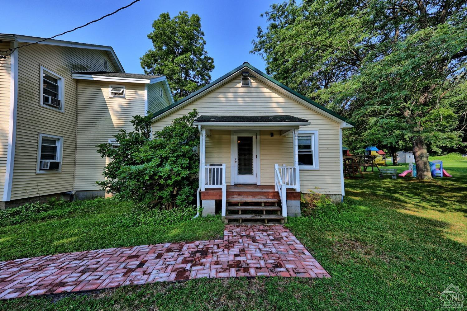 899-907 Red Mill Road Greenville, NY 12083 - Photo 39 of 99 a front view of a house with a garden