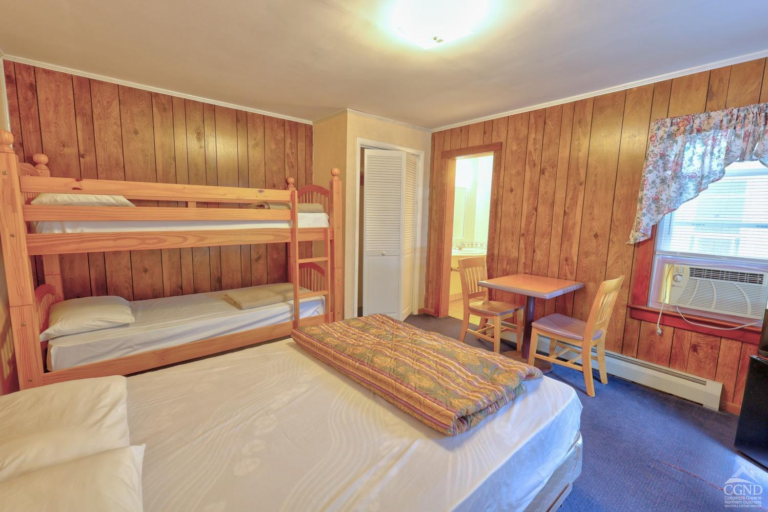 899-907 Red Mill Road Greenville, NY 12083 - Photo 48 of 99 a bedroom with a bed and a dresser with wooden floor