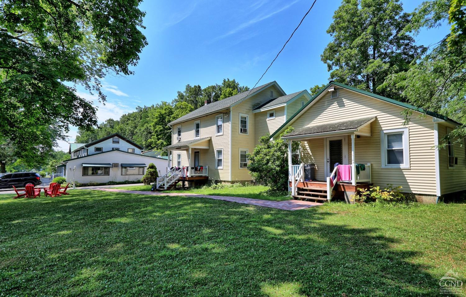 899-907 Red Mill Road Greenville, NY 12083 - Photo 81 of 99 a front view of a house with a garden and trees