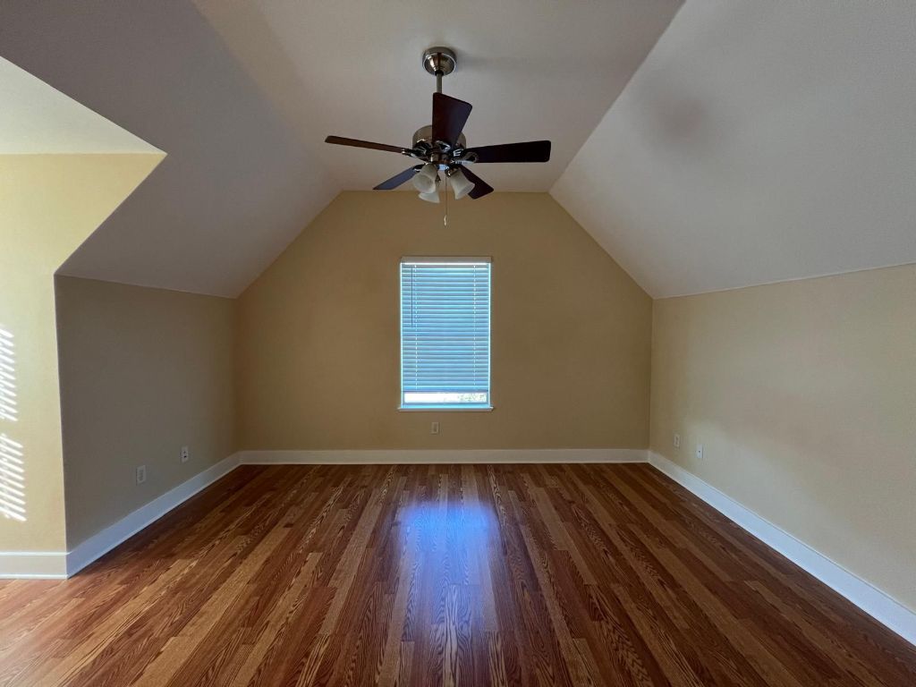 1309 Olander Street, Unit B Austin, TX 78702 - Photo 12 of 17 wooden floor in an empty room with a window