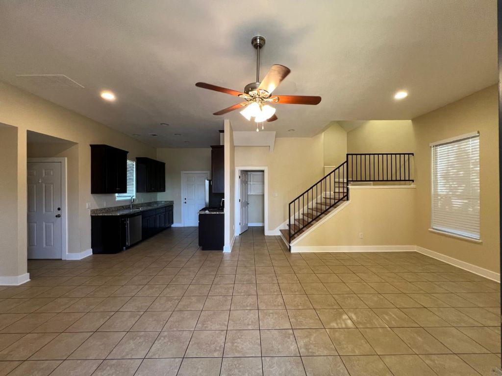 1309 Olander Street, Unit B Austin, TX 78702 - Photo 4 of 17 a view of an empty room with kitchen view and a window