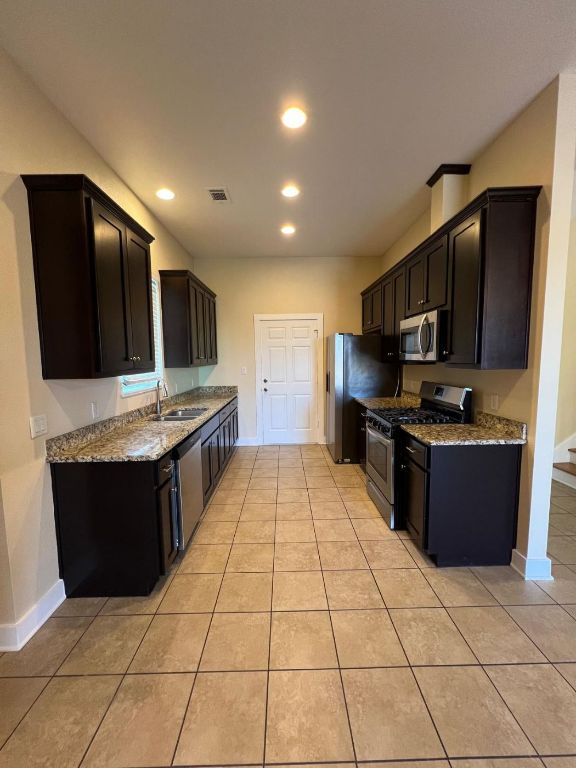 1309 Olander Street, Unit B Austin, TX 78702 - Photo 6 of 17 a kitchen with stainless steel appliances granite countertop a refrigerator and a stove