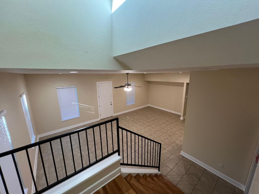 1309 Olander Street, Unit B Austin, TX 78702 - Photo 9 of 17 a view of staircase with lots of frames on wall and wooden floor