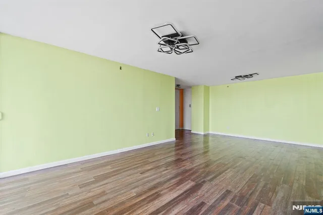 a view of a room with wooden floor and fence