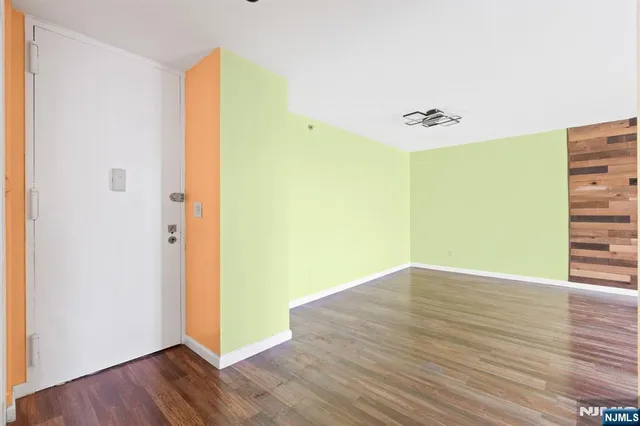 a view of a room with wooden floor