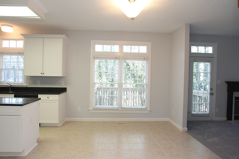 9021 Breeland Way Raleigh, NC 27613 - Photo 8 of 20 Say good morning cheerfully in this continuation of kitchen into dining area. Huge windows with transoms with private view of private backyard! Openness continues into family area. Casual dining area