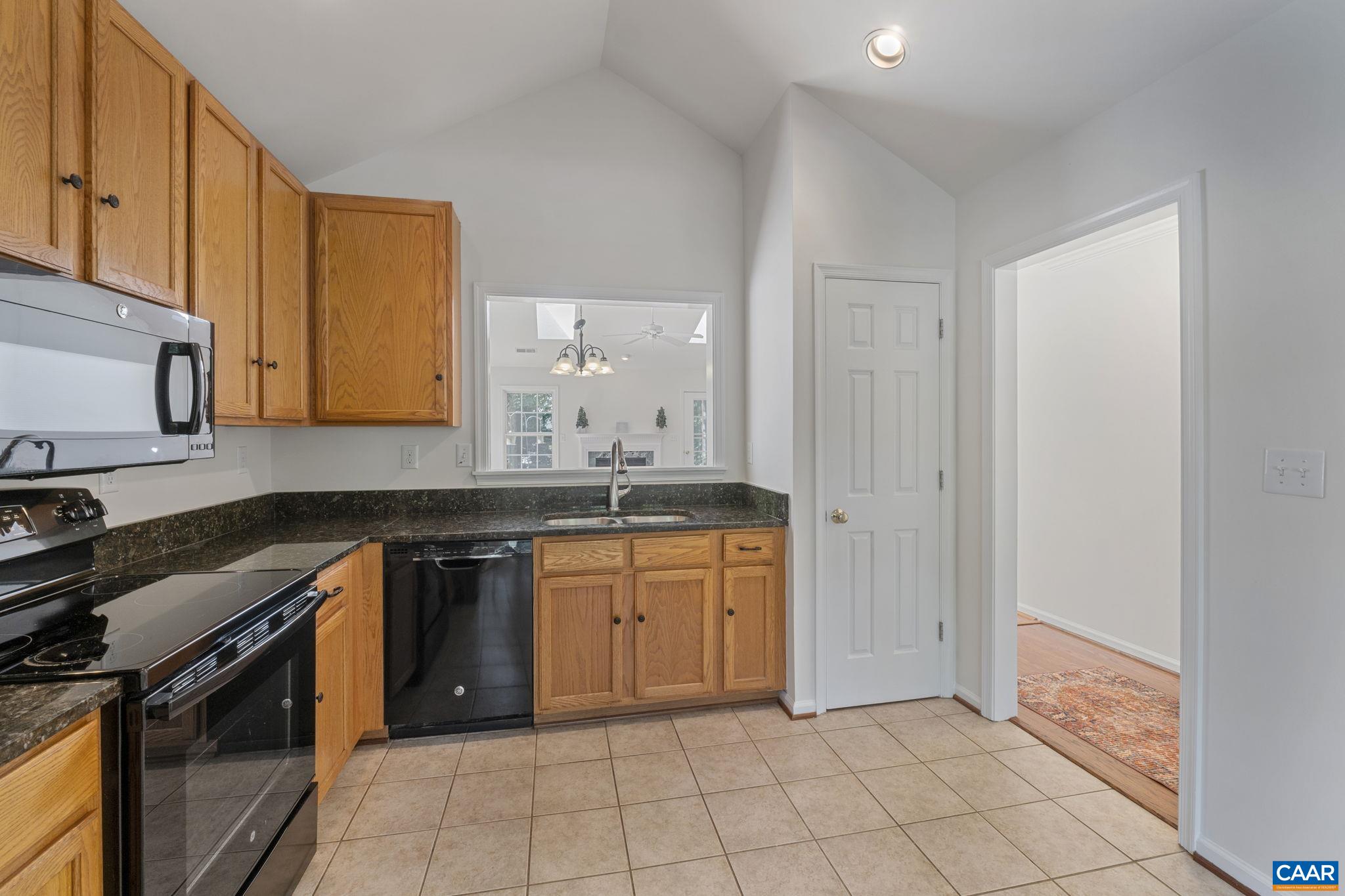 298 Northridge Road Ruckersville, VA 22968 - Photo 13 of 33 a kitchen with granite countertop a sink stove and cabinets