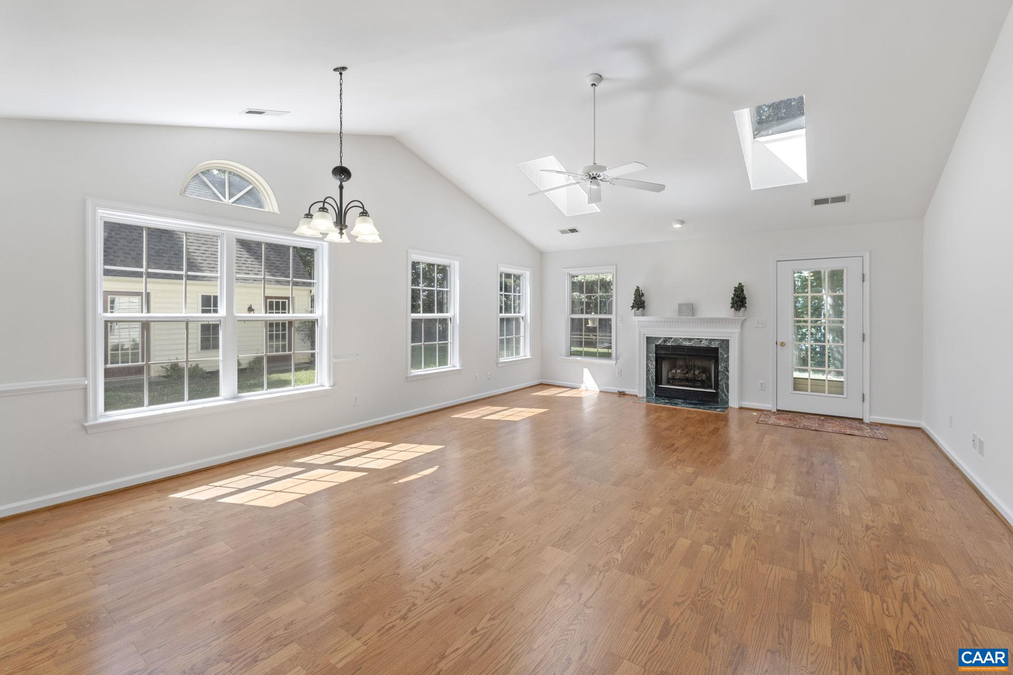 298 Northridge Road Ruckersville, VA 22968 - Photo 16 of 33 an empty room with fireplace wooden floor and windows