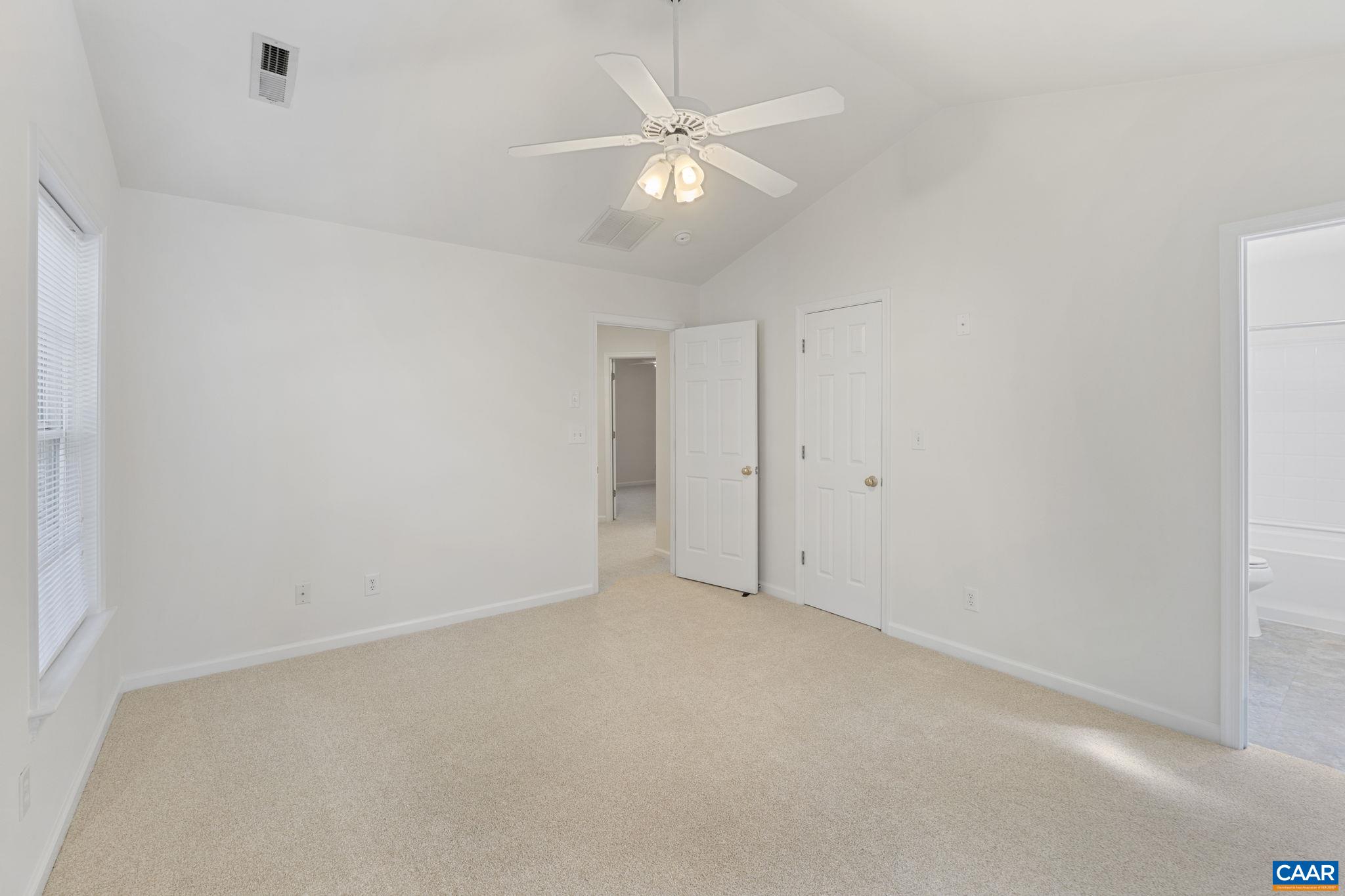 298 Northridge Road Ruckersville, VA 22968 - Photo 24 of 33 an empty room with a chandelier fan and windows