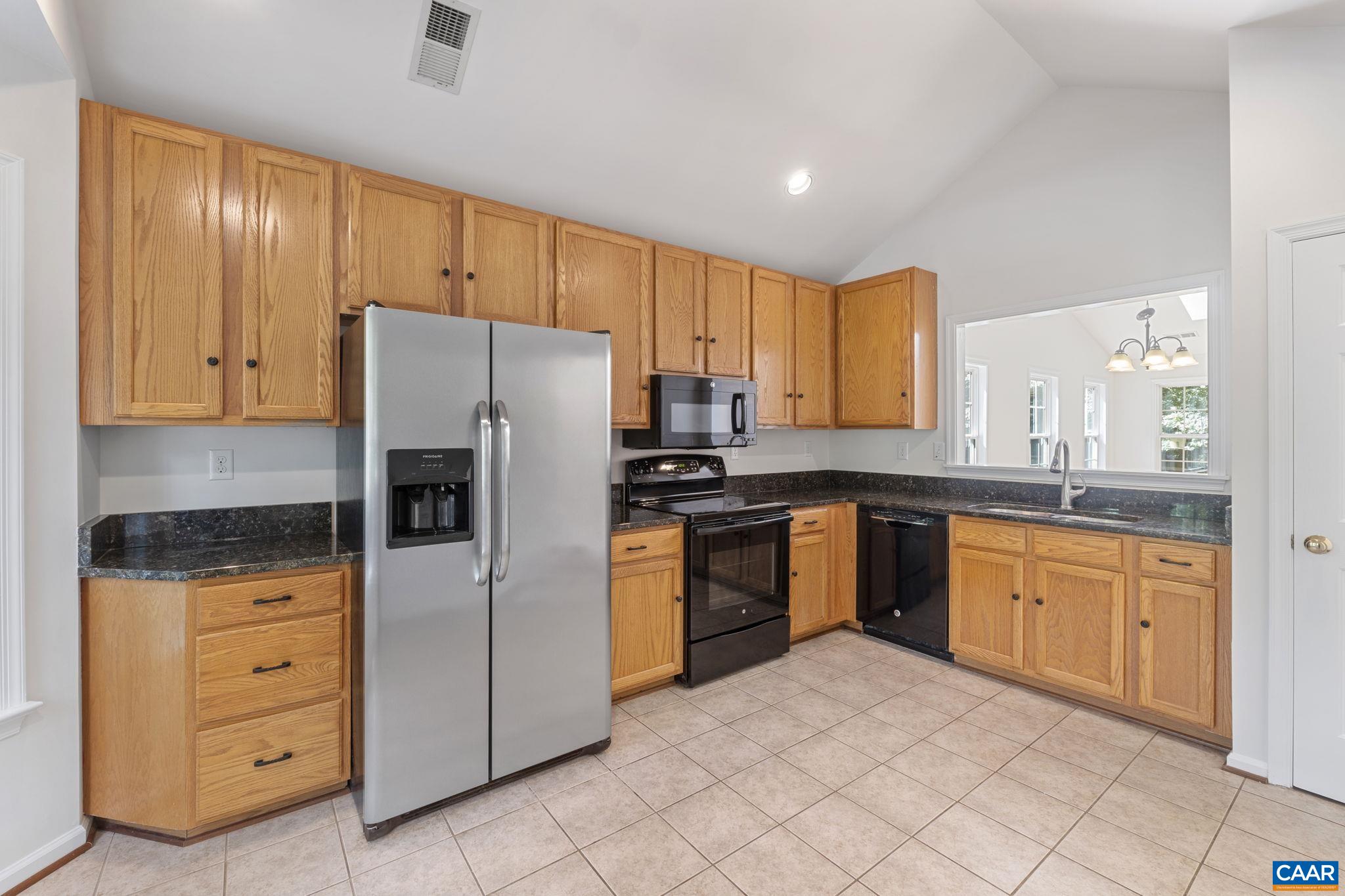 298 Northridge Road Ruckersville, VA 22968 - Photo 10 of 33 a kitchen with granite countertop a refrigerator sink and cabinets