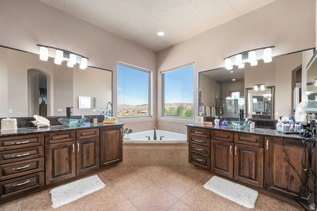 2376 Stone Crest Circle St. George, UT 84790 - Photo 25 of 61 Bathroom with two vanities, a garden tub, and a stall shower