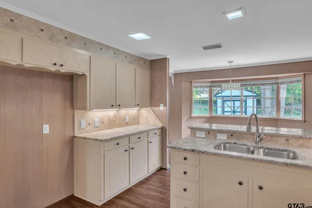 a bathroom with double sink and a window