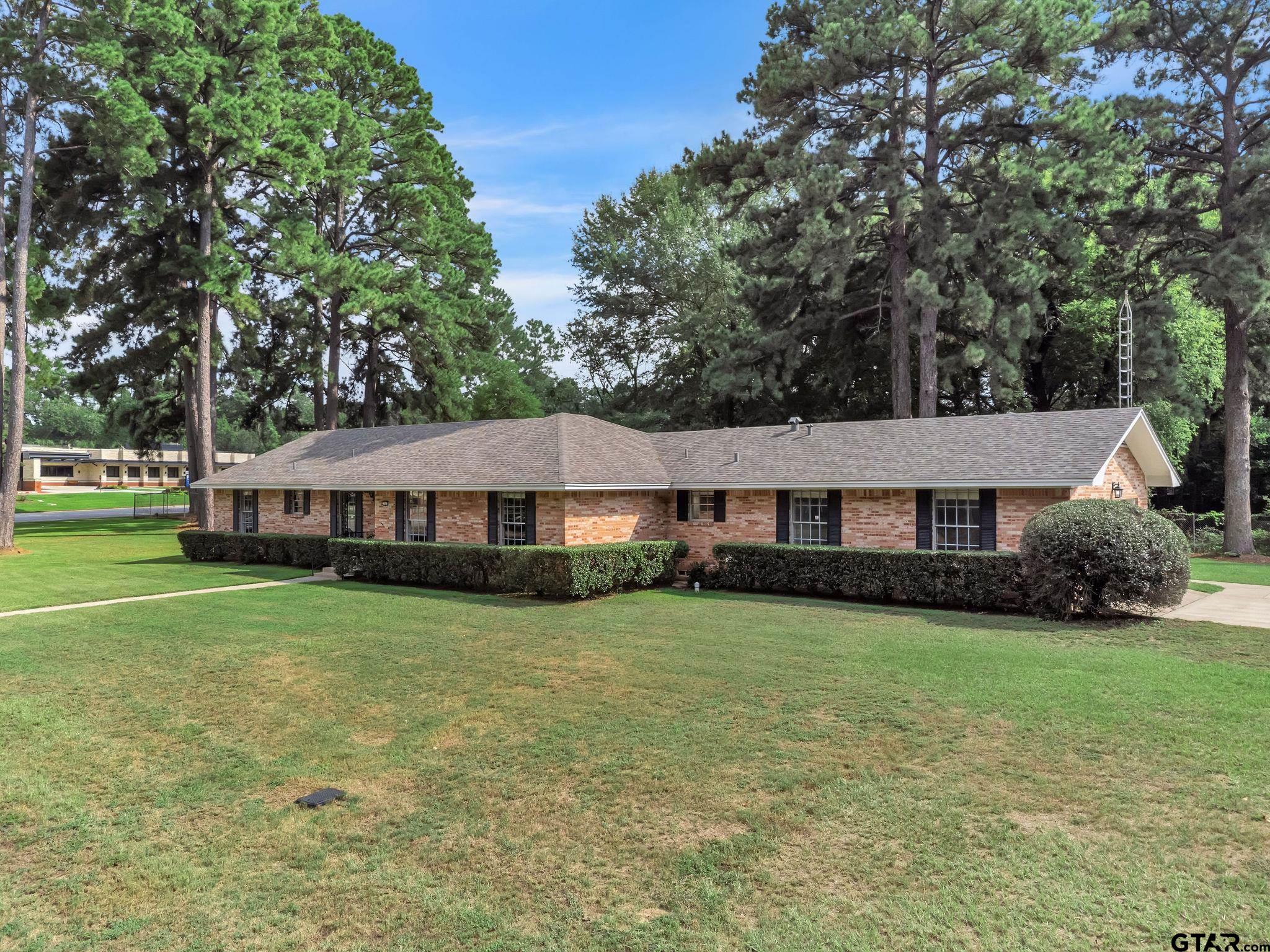 700 Emily Drive Longview, TX 75601 - Photo 18 of 45 a view of a house with a big yard and large trees
