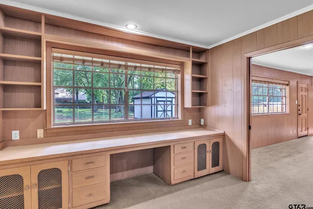 a view of a kitchen with a sink and a large window