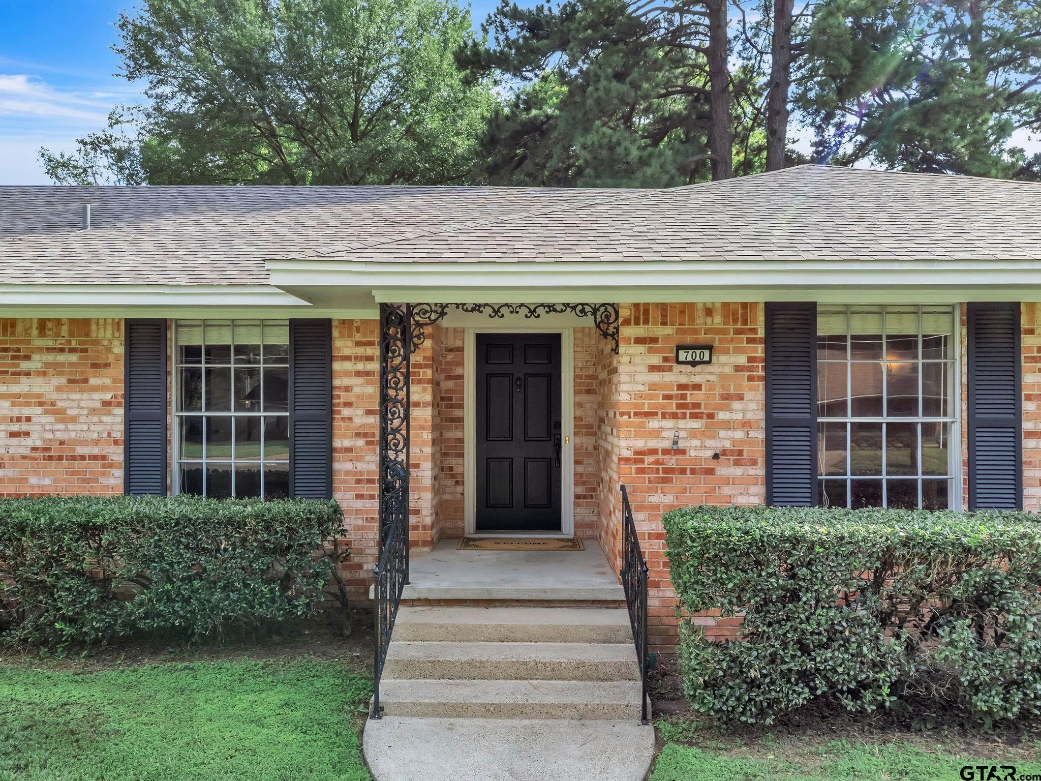 700 Emily Drive Longview, TX 75601 - Photo 2 of 45 a front view of a house with a garden