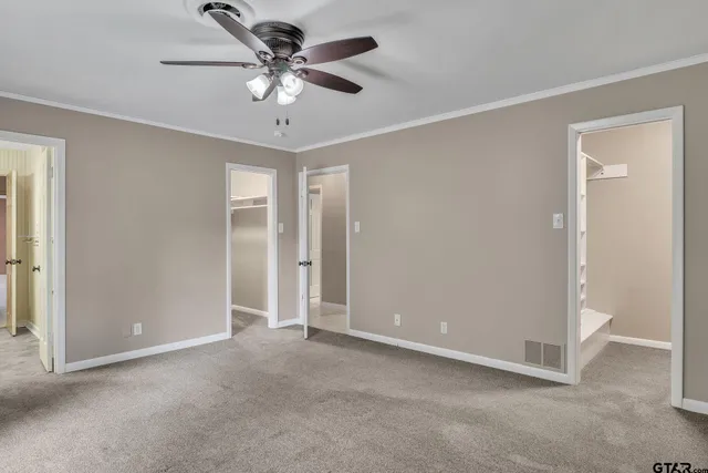 a view of an empty room with a ceiling fan