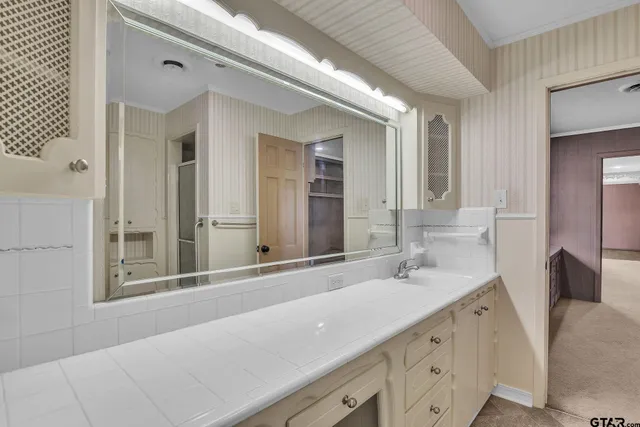 a bathroom with a double vanity sink and a mirror