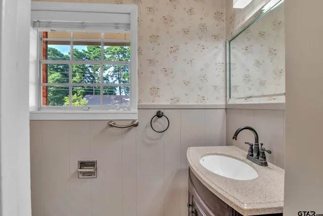 a bathroom with a sink and a mirror