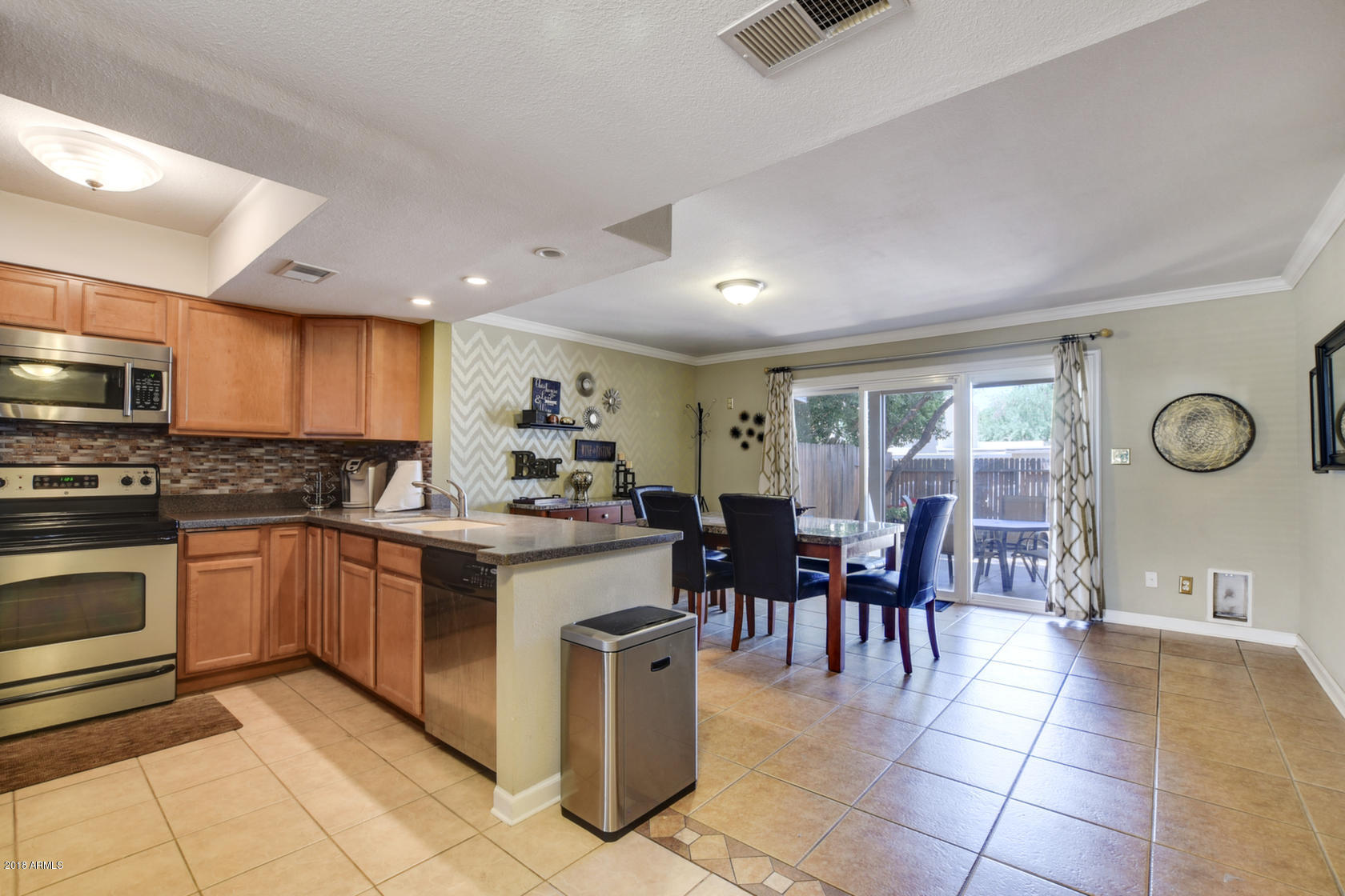 5910 North Granite Reef Road Scottsdale, AZ 85250 - Photo 11 of 33 a open kitchen with cabinets table and chairs
