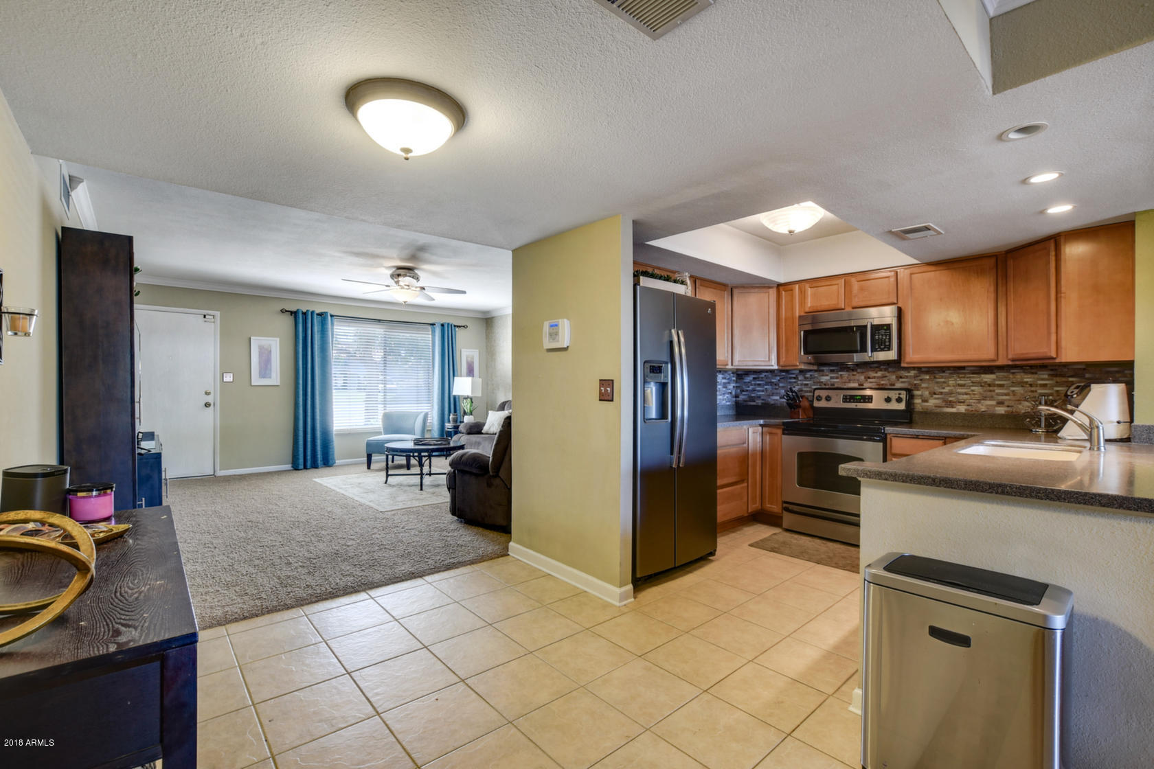 5910 North Granite Reef Road Scottsdale, AZ 85250 - Photo 12 of 33 a kitchen with stainless steel appliances granite countertop a refrigerator stove and sink