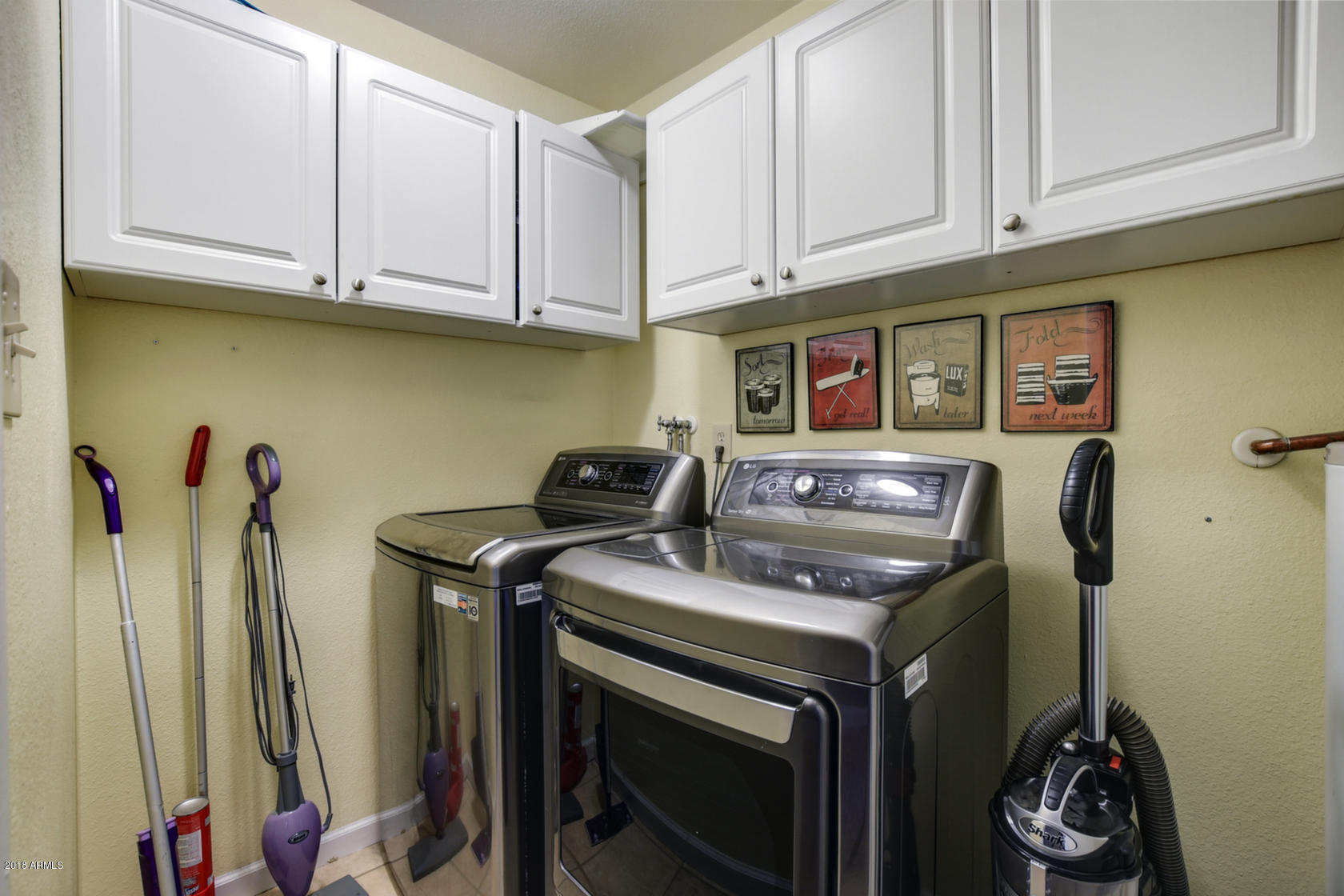 5910 North Granite Reef Road Scottsdale, AZ 85250 - Photo 25 of 33 a kitchen with stainless steel appliances granite countertop a stove and a refrigerator