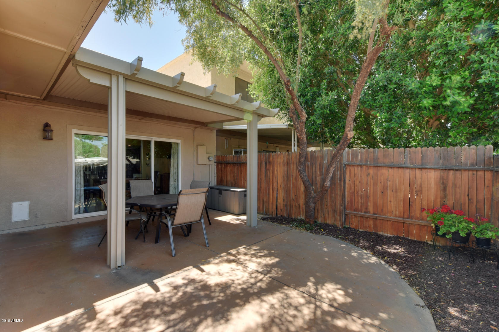 5910 North Granite Reef Road Scottsdale, AZ 85250 - Photo 27 of 33 a view of a patio with table and chairs and wooden fence