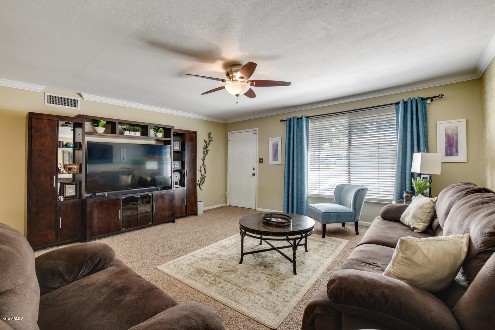 5910 North Granite Reef Road Scottsdale, AZ 85250 - Photo 3 of 33 a living room with furniture and a flat screen tv