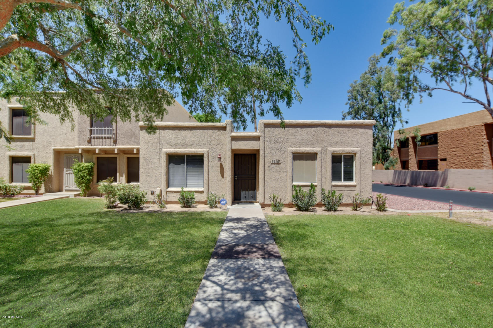5910 North Granite Reef Road Scottsdale, AZ 85250 - Photo 33 of 33 a front view of a house with a yard and sitting area