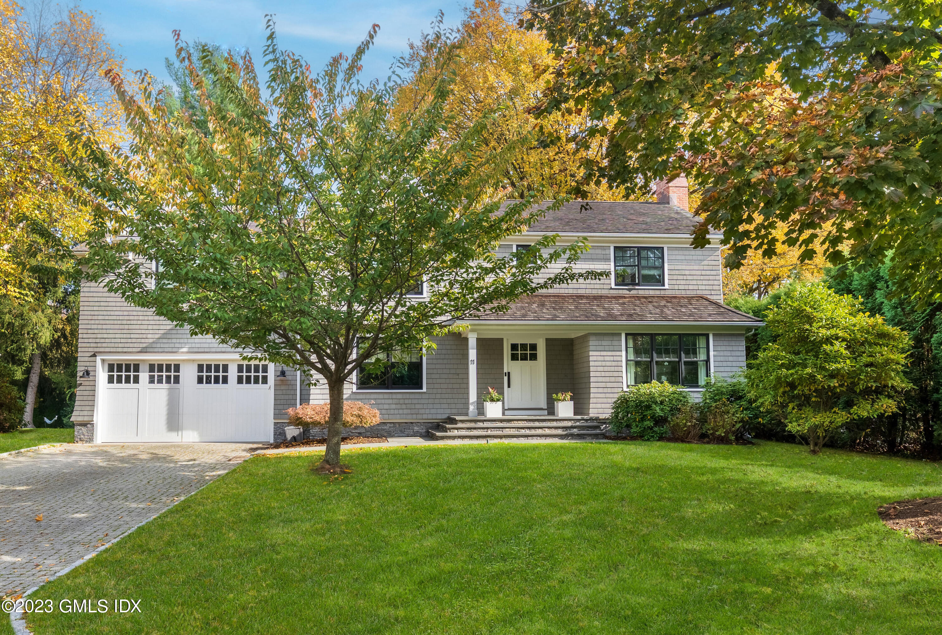 11 Colonial Lane Riverside, CT 06878 - Photo 1 of 37 a front view of a house with a yard
