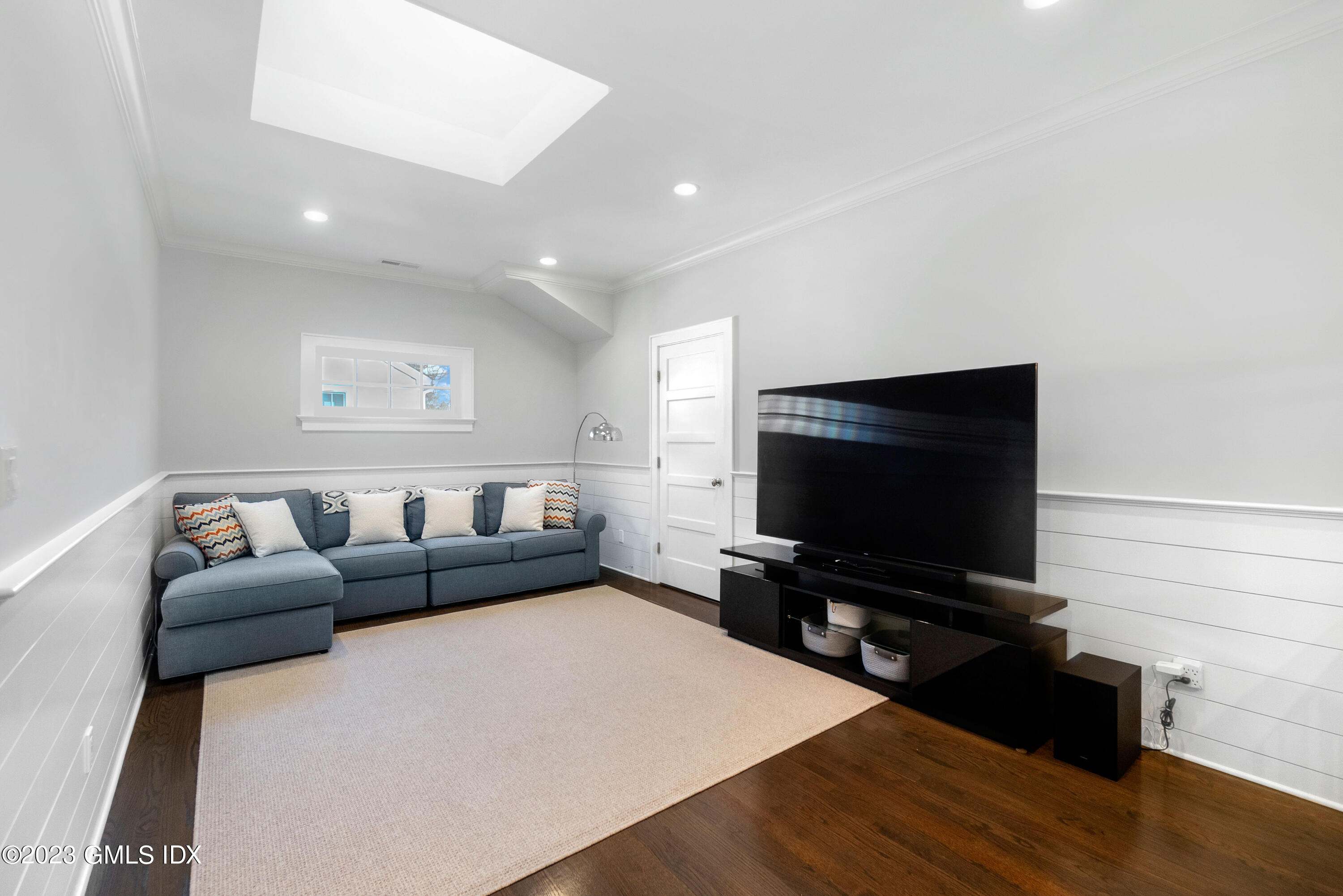 11 Colonial Lane Riverside, CT 06878 - Photo 26 of 37 a living room with furniture and a flat screen tv