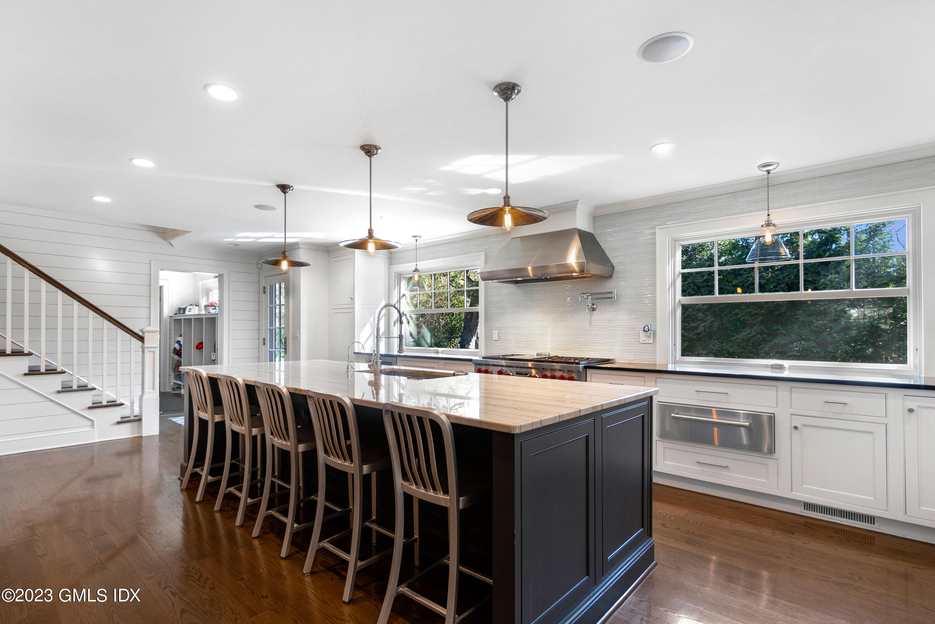 11 Colonial Lane Riverside, CT 06878 - Photo 7 of 37 a kitchen with kitchen island a large island in it