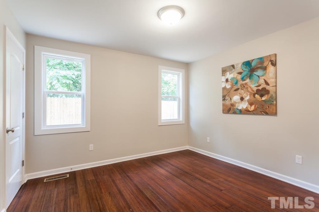 509 Freeman Street Raleigh, NC 27601 - Photo 15 of 20 an empty room with wooden floor and windows