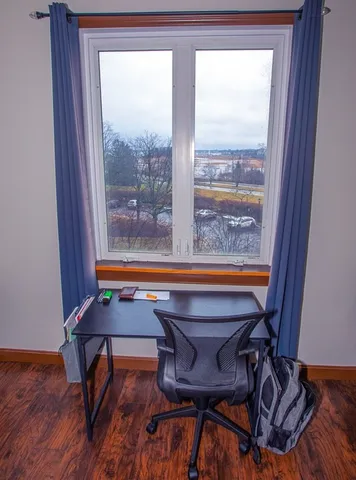 a view of a room with lounge chair and windows