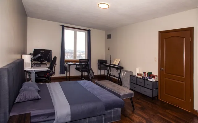 a bed room with a bed and a television