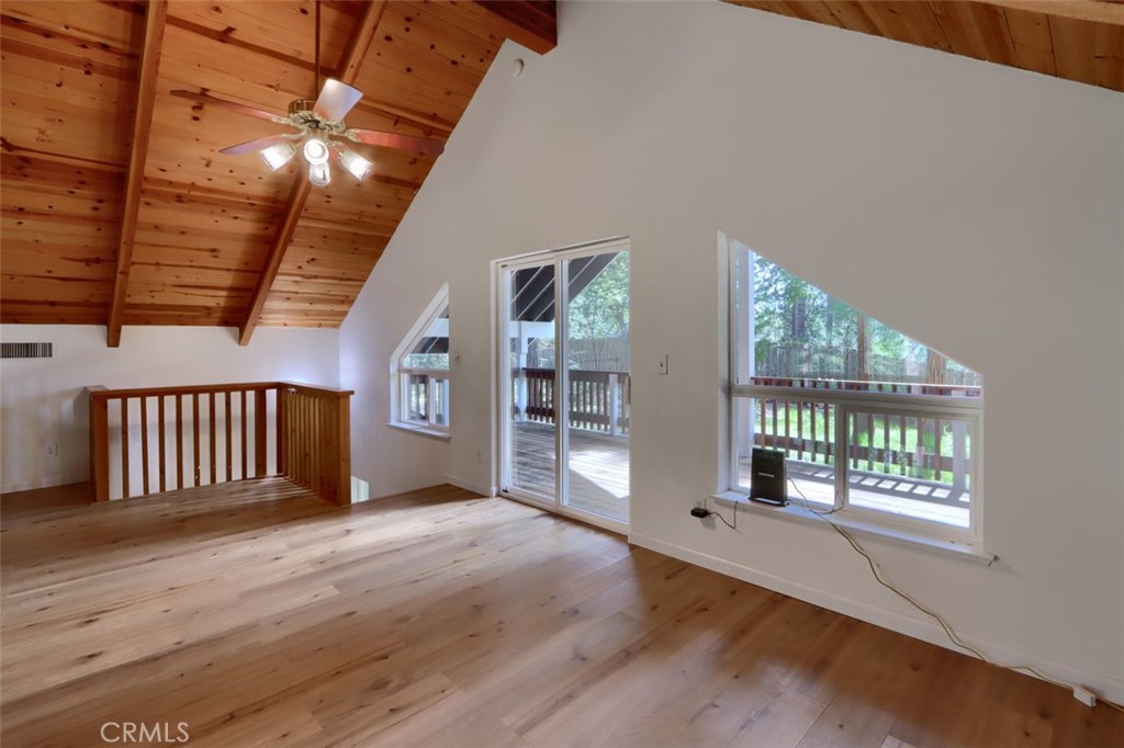 7174 Hites Cove Road Mariposa, CA 95338 - Photo 16 of 62 a view of an empty room with wooden floor and a window