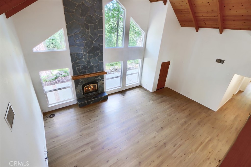 7174 Hites Cove Road Mariposa, CA 95338 - Photo 21 of 62 a view of an empty room with wooden floor and a window