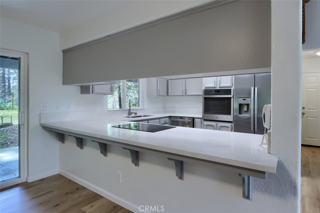 7174 Hites Cove Road Mariposa, CA 95338 - Photo 25 of 62 a kitchen with a sink cabinets and window