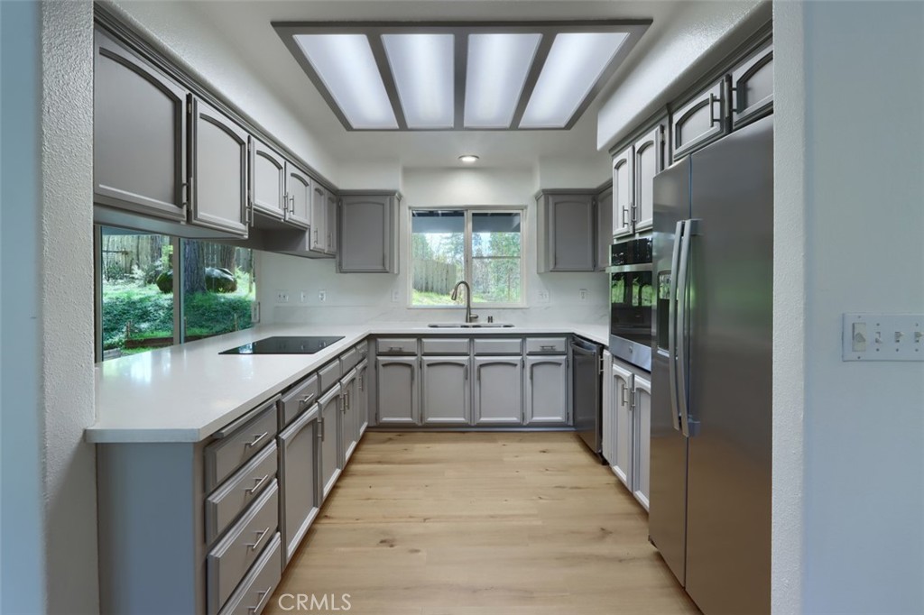 7174 Hites Cove Road Mariposa, CA 95338 - Photo 26 of 62 a large kitchen with stainless steel appliances granite countertop a large counter top a stove and a refrigerator