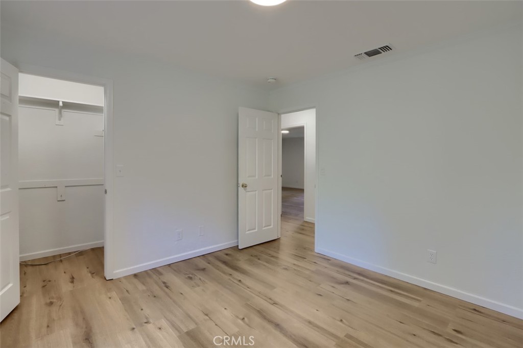 7174 Hites Cove Road Mariposa, CA 95338 - Photo 33 of 62 a view of an empty room with wooden floor and a window
