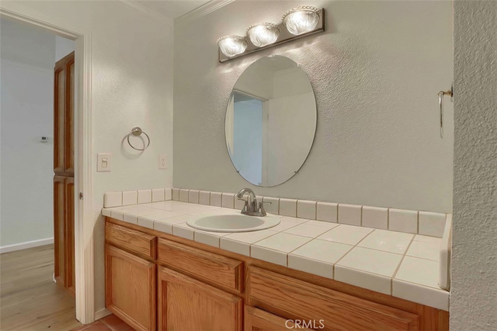 7174 Hites Cove Road Mariposa, CA 95338 - Photo 34 of 62 a bathroom with a sink and a mirror
