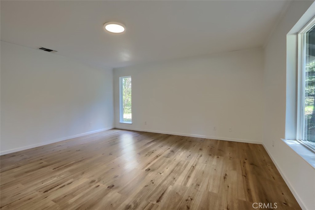 7174 Hites Cove Road Mariposa, CA 95338 - Photo 41 of 62 an empty room with wooden floor and windows