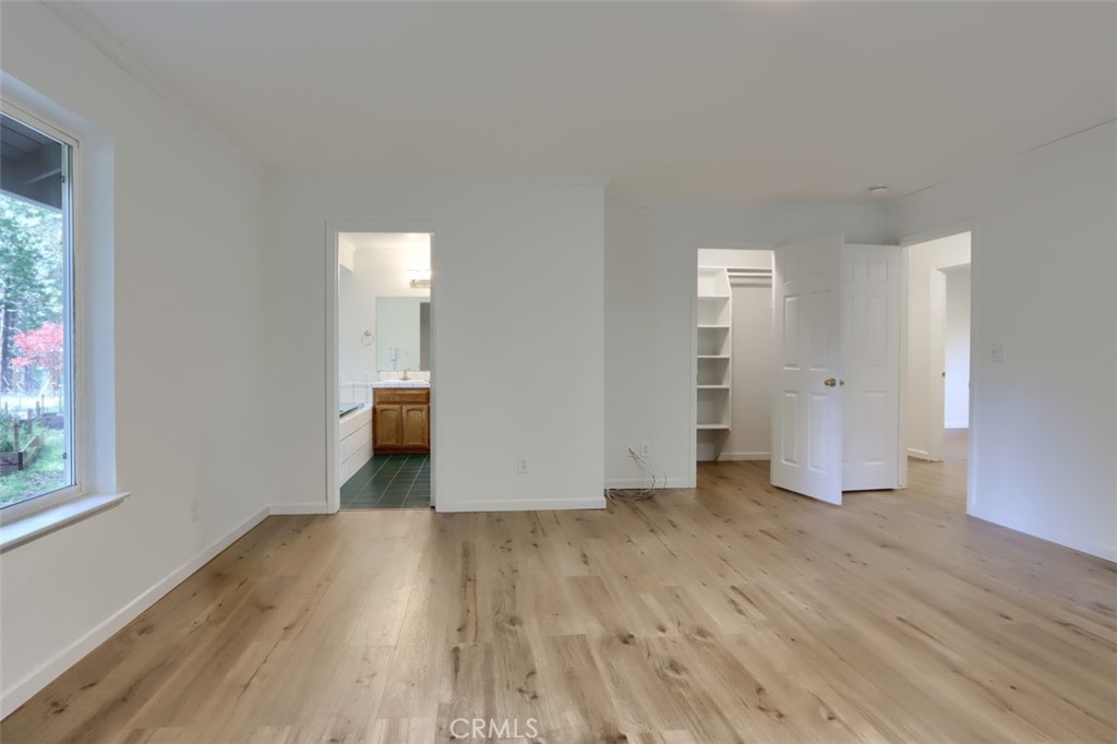 7174 Hites Cove Road Mariposa, CA 95338 - Photo 42 of 62 an empty room with wooden floor and windows