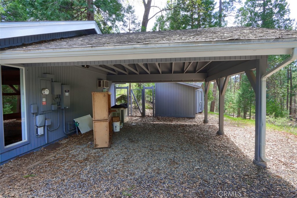 7174 Hites Cove Road Mariposa, CA 95338 - Photo 52 of 62 a view of a patio with table and chairs under an umbrella