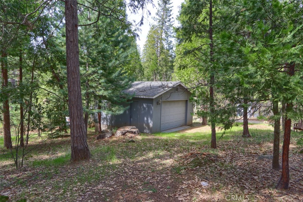 7174 Hites Cove Road Mariposa, CA 95338 - Photo 56 of 62 a view of a backyard with large trees and a barn