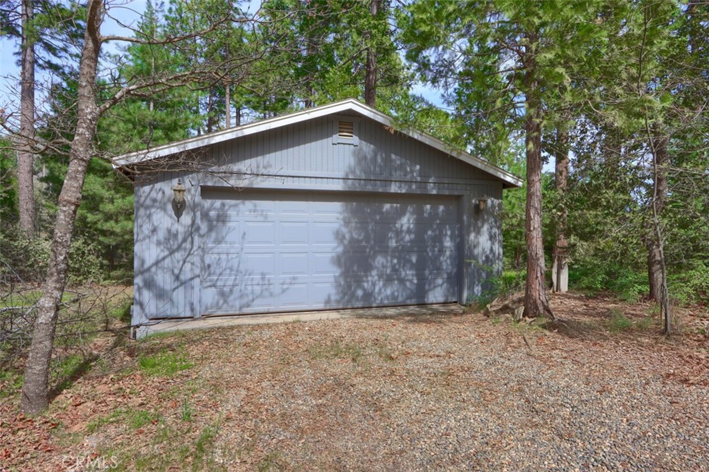 7174 Hites Cove Road Mariposa, CA 95338 - Photo 60 of 62 a view of a house with large trees and wooden fence