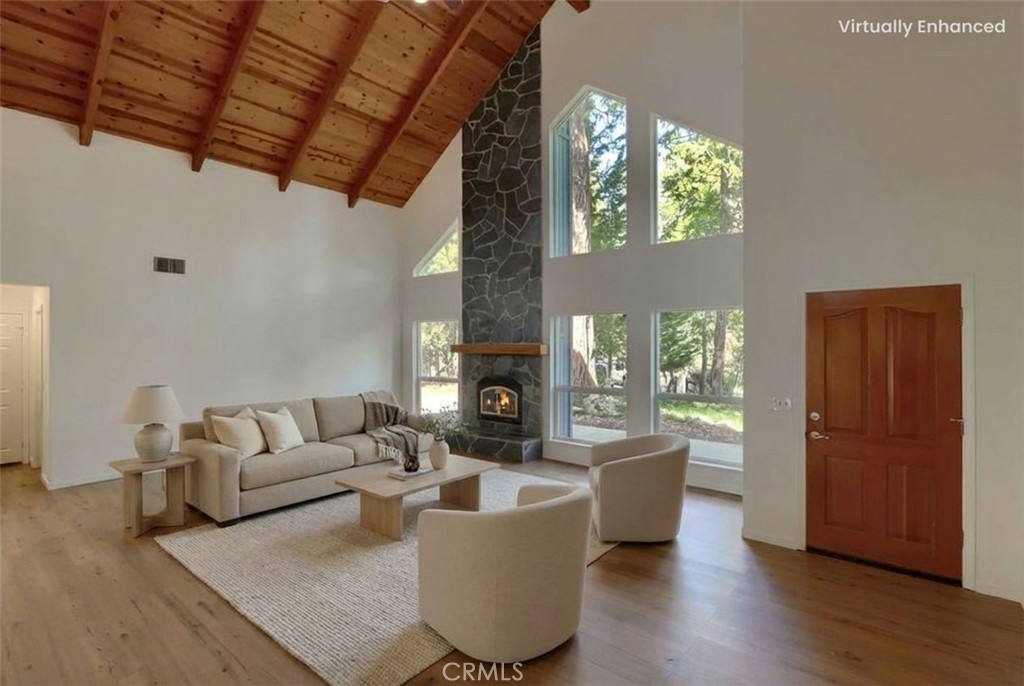 7174 Hites Cove Road Mariposa, CA 95338 - Photo 7 of 62 a living room with furniture a fireplace and a large window