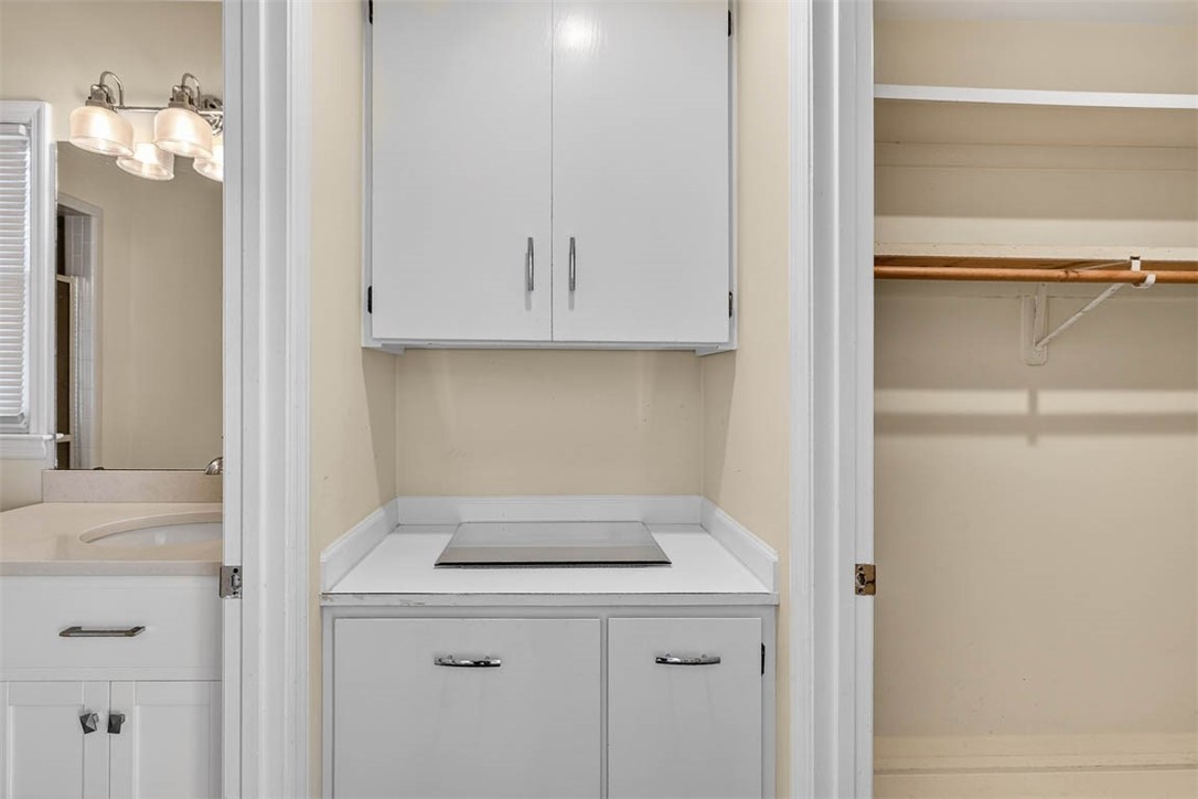 201 Five Pounds Road St. Simons Island, GA 31522 - Photo 26 of 37 Primary bath dressing area with hidden laundry basket