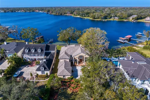 an aerial view of a houses with a lake view